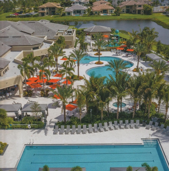 view of pool with a patio area and a water view