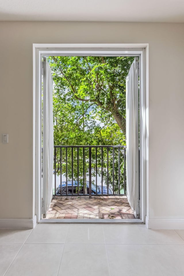 doorway to outside with light tile patterned floors