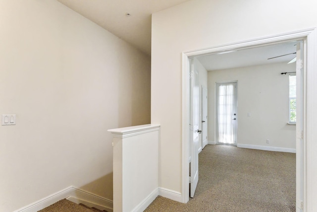 hall with light colored carpet