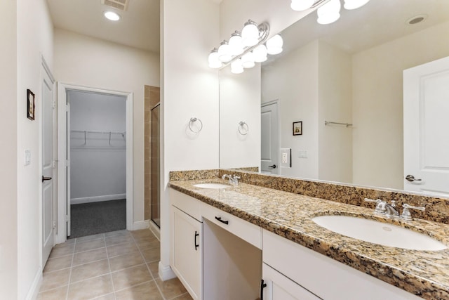 bathroom with tile patterned flooring, an enclosed shower, and vanity