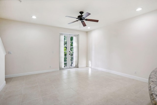 tiled spare room featuring ceiling fan