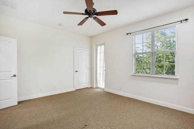 empty room featuring ceiling fan and carpet flooring