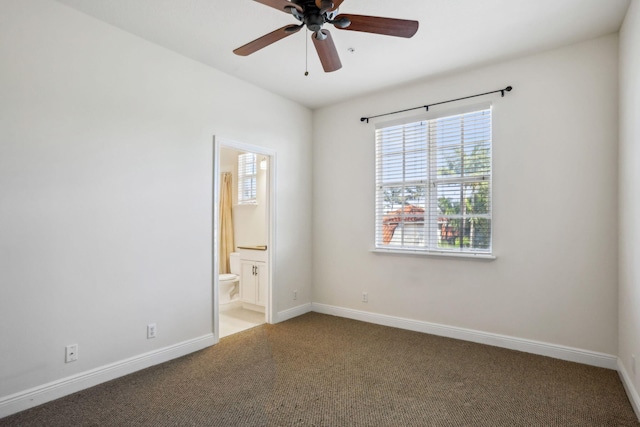 carpeted spare room featuring ceiling fan