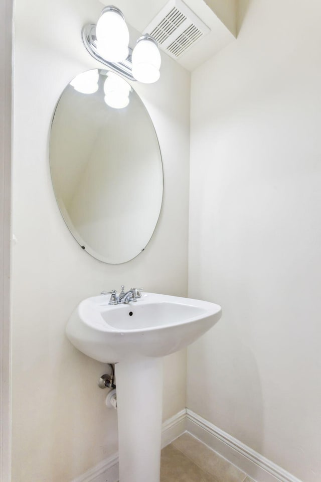 bathroom with sink and tile patterned flooring