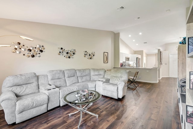 living room with vaulted ceiling and dark hardwood / wood-style flooring