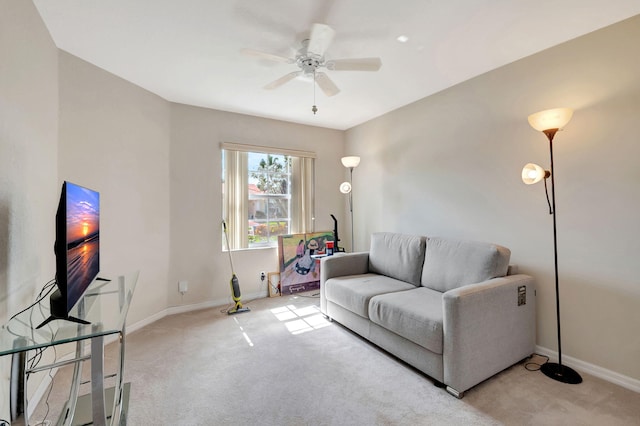 carpeted living room with ceiling fan