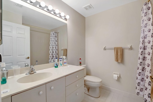 bathroom with vanity, toilet, and tile patterned flooring