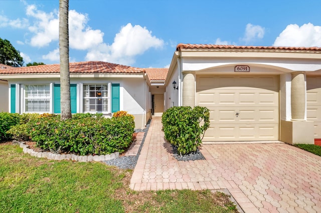 mediterranean / spanish house featuring a garage