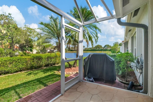 unfurnished sunroom with a water view