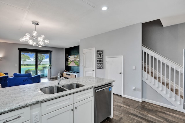 kitchen with dark wood-type flooring, white cabinets, sink, stainless steel dishwasher, and decorative light fixtures