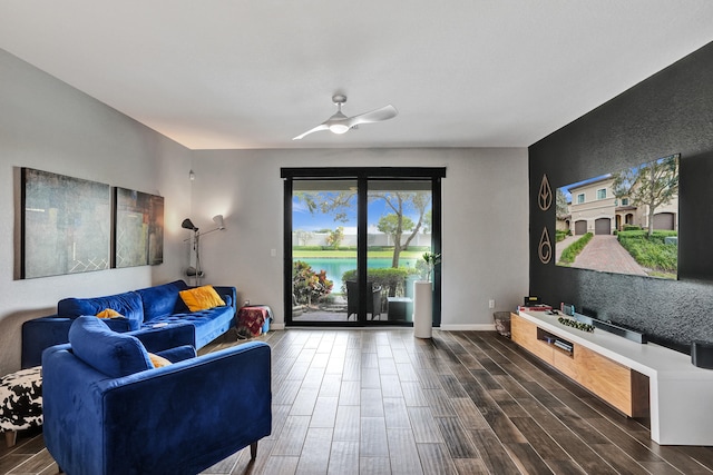 living room featuring dark wood-type flooring and ceiling fan