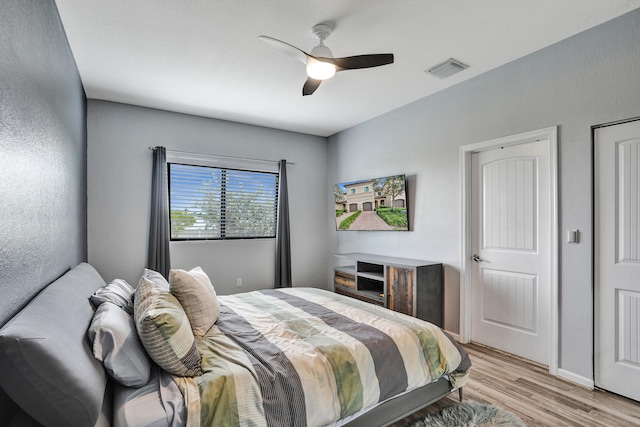 bedroom with ceiling fan and light hardwood / wood-style flooring