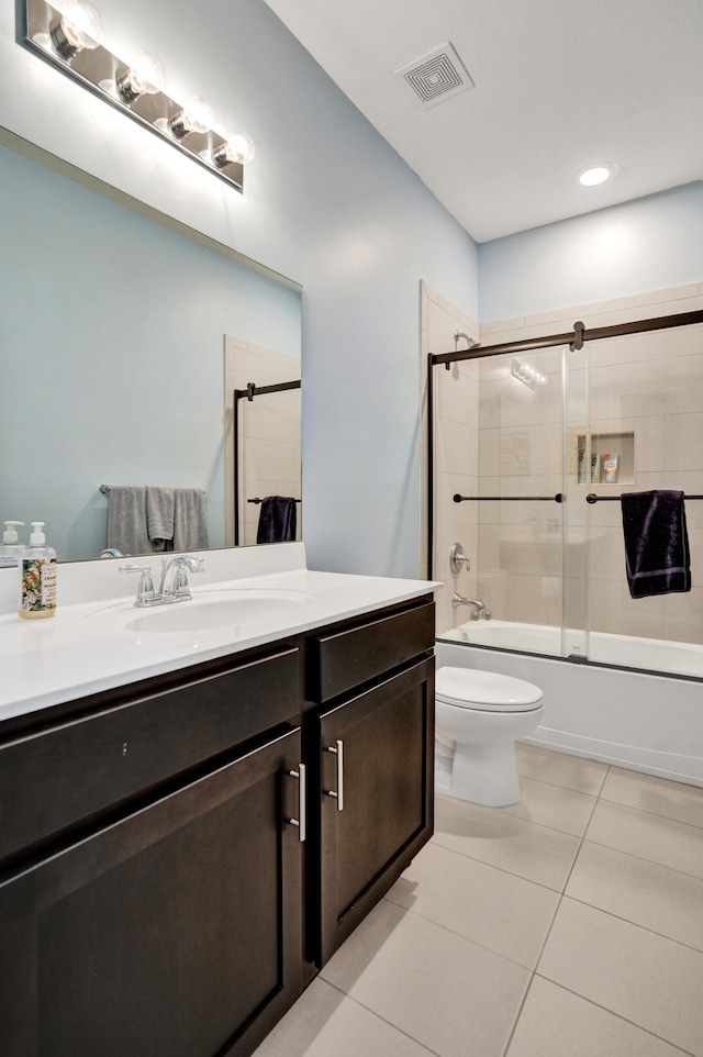 full bathroom with bath / shower combo with glass door, vanity, toilet, and tile patterned flooring