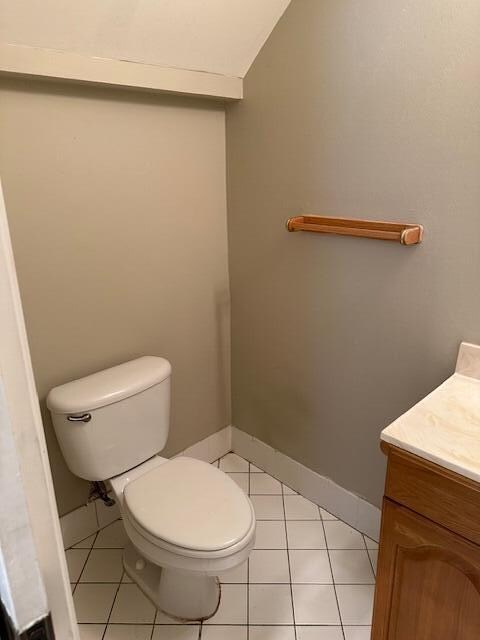 bathroom with vanity, toilet, and tile patterned flooring