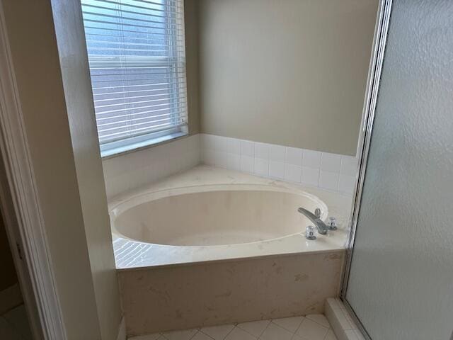 bathroom featuring independent shower and bath and tile patterned flooring