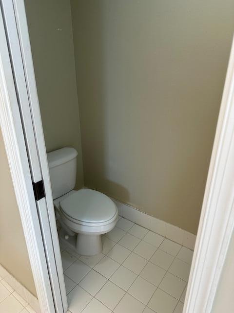 bathroom with toilet and tile patterned flooring