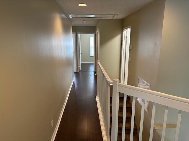 corridor with dark hardwood / wood-style flooring