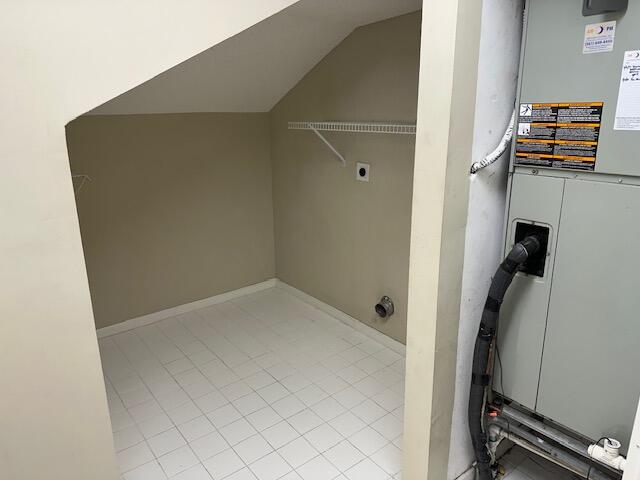 clothes washing area featuring electric dryer hookup and heating unit