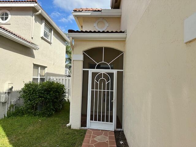 doorway to property featuring a yard