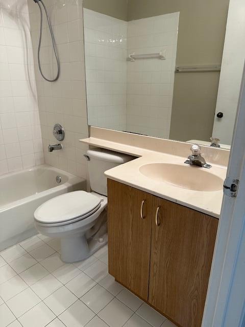 full bathroom featuring vanity, toilet, tile patterned floors, and tiled shower / bath combo