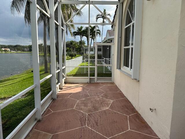 unfurnished sunroom with a water view