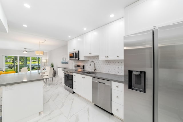 2801 N Palm Aire Dr Unit 106, Pompano Beach, FL 33069 - kitchen with a sink, stainless steel appliances, marble finish floor, recessed lighting, and white cabinetry