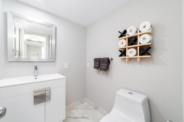 bathroom featuring toilet and vanity