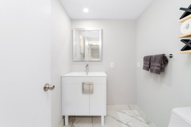 bathroom with toilet and vanity