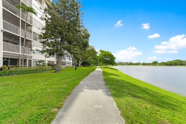 surrounding community with a yard and a water view