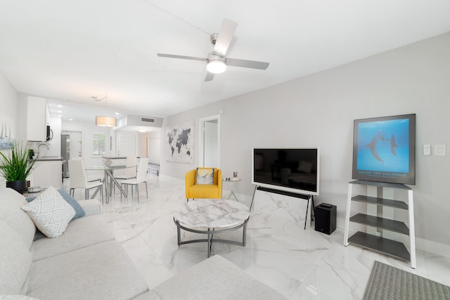 living room with ceiling fan and sink