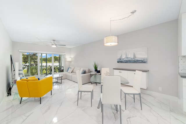 2801 N Palm Aire Dr Unit 106, Pompano Beach, FL 33069 - dining area with ceiling fan, baseboards, and marble finish floor
