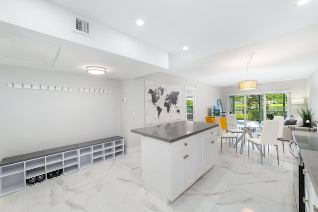 2801 N Palm Aire Dr Unit 106, Pompano Beach, FL 33069 - kitchen featuring dark countertops, white cabinets, visible vents, marble finish floor, and recessed lighting