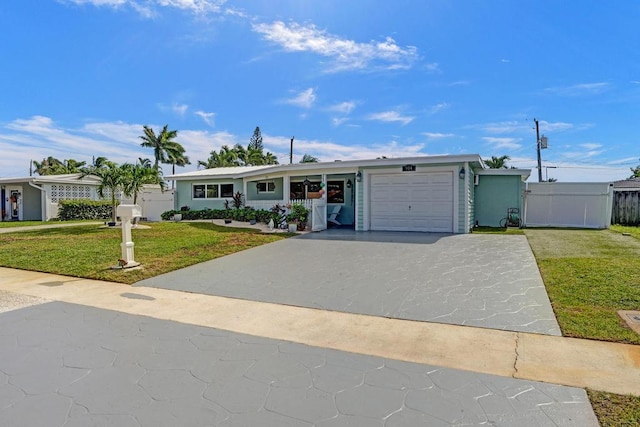 ranch-style home featuring a garage and a front lawn