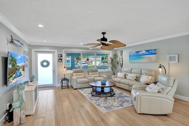 living room featuring crown molding, ceiling fan, and light wood-type flooring