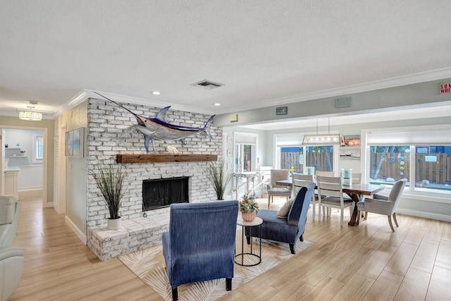 living room with crown molding, a healthy amount of sunlight, and light hardwood / wood-style floors