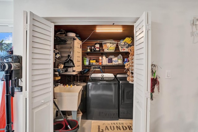 clothes washing area with sink and washing machine and clothes dryer