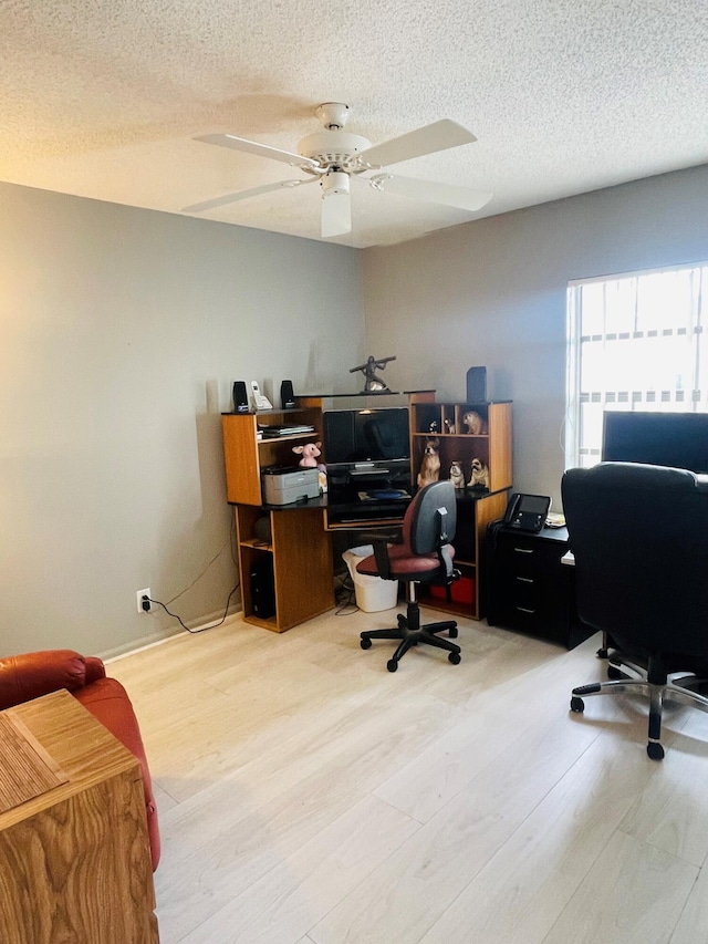 office area featuring ceiling fan and a textured ceiling