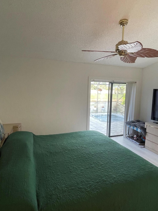 bedroom with ceiling fan, a textured ceiling, and access to outside