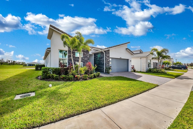 view of front facade featuring a garage and a front lawn