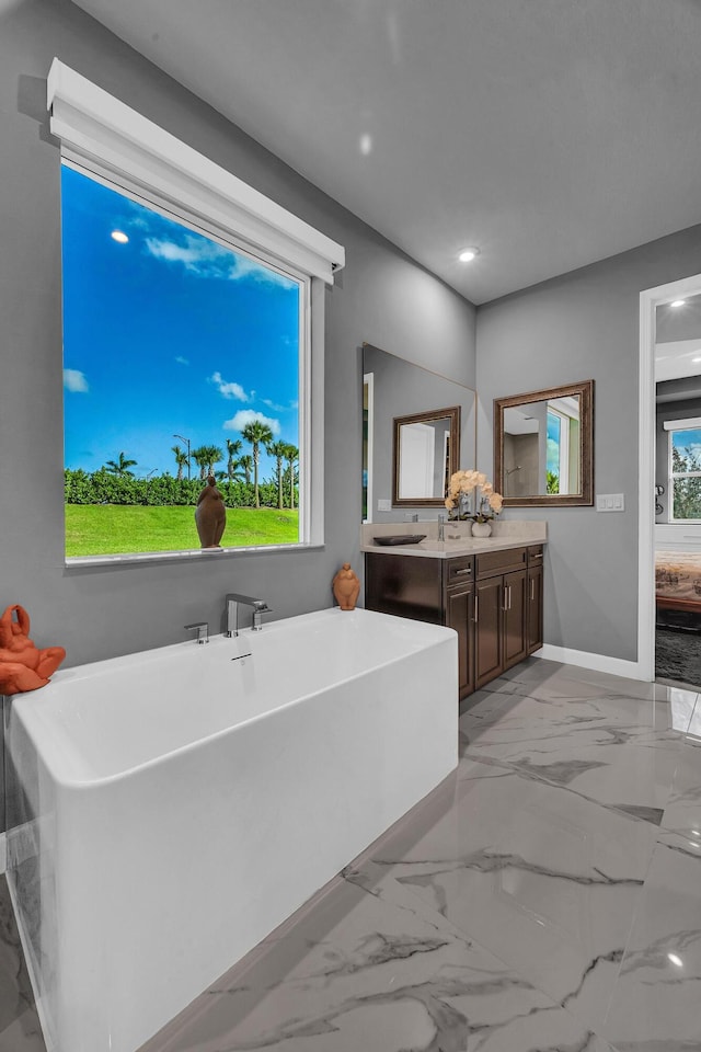 bathroom with vanity and a tub to relax in