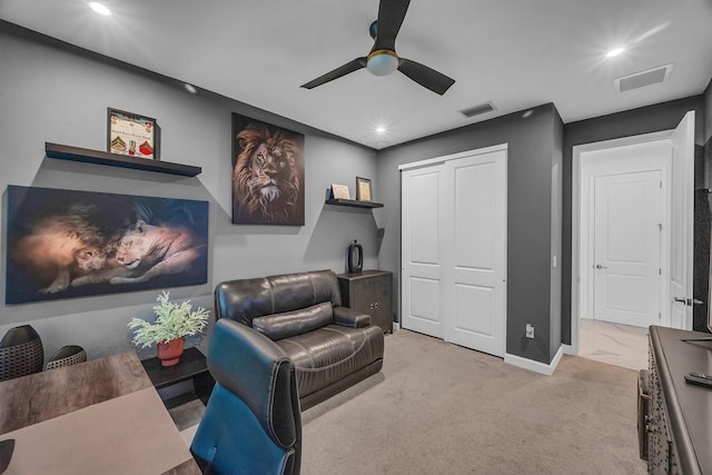 interior space with light carpet and ceiling fan