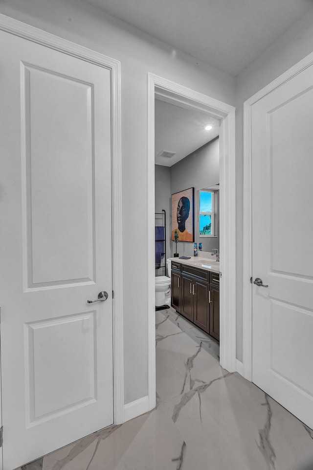 bathroom featuring toilet and vanity