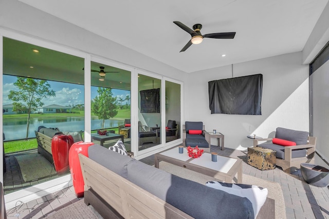 view of patio featuring an outdoor hangout area, a water view, and ceiling fan