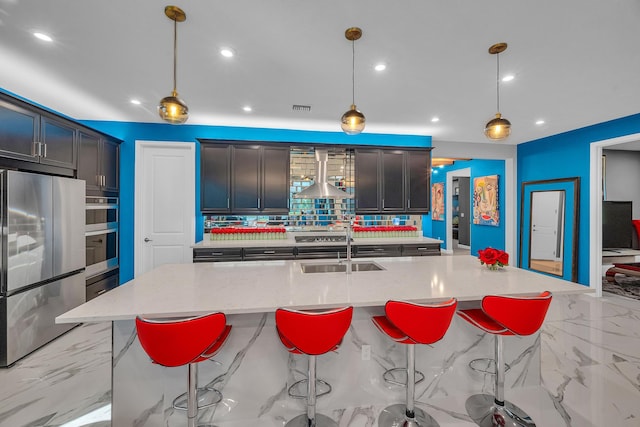 kitchen featuring range hood, a large island with sink, stainless steel appliances, and pendant lighting