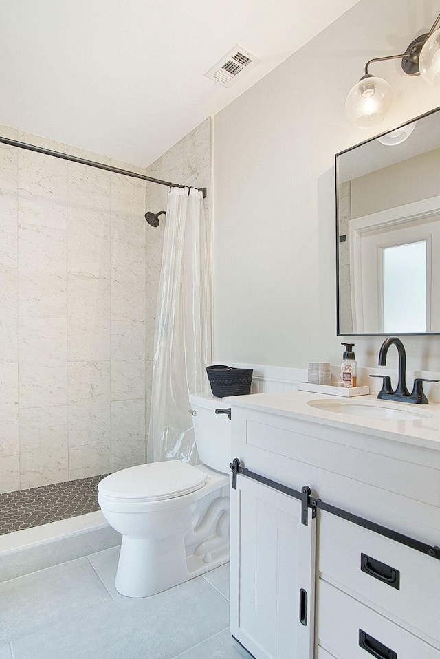 bathroom featuring toilet, vanity, tile patterned flooring, and curtained shower