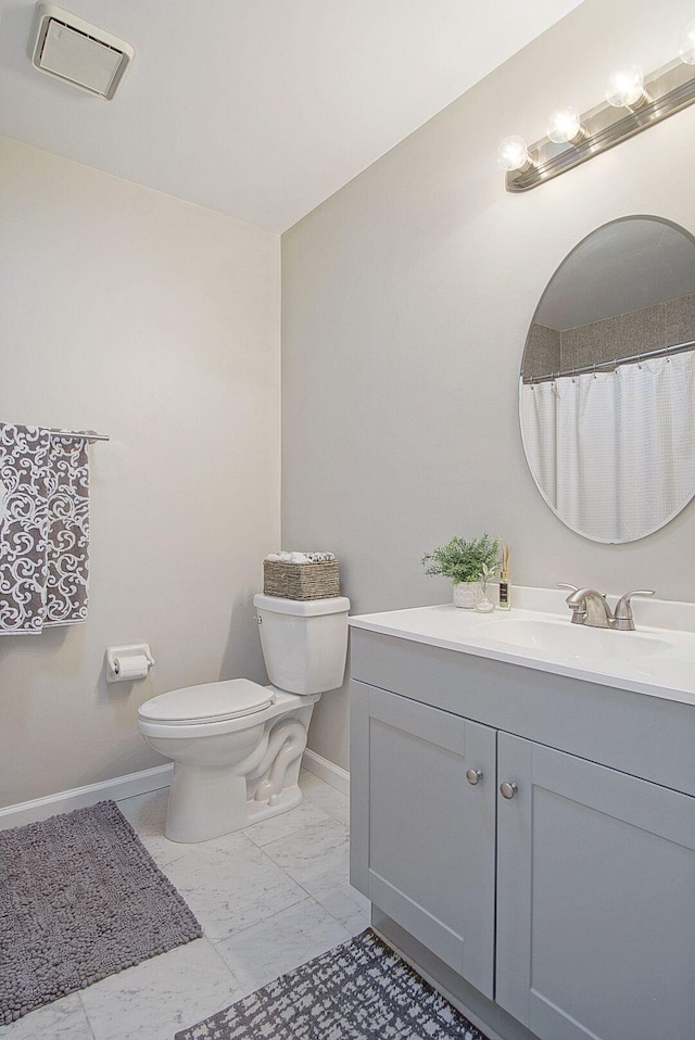 bathroom featuring toilet and vanity