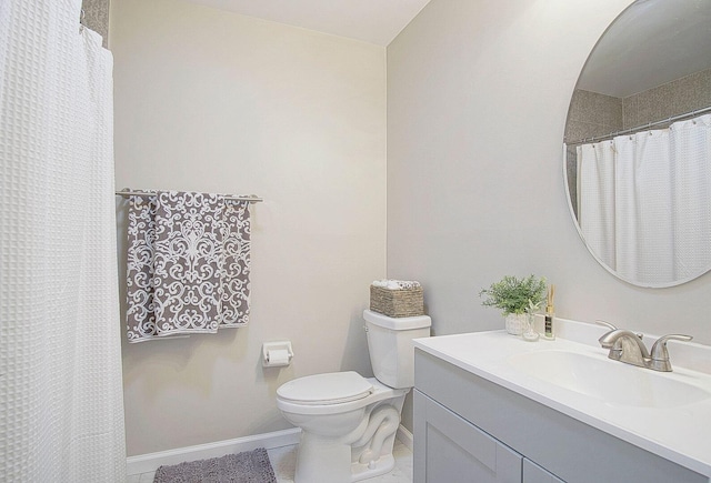 bathroom with tile patterned floors, vanity, and toilet