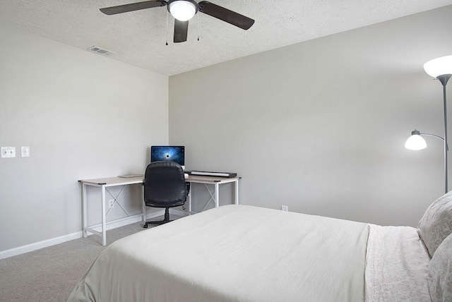 carpeted bedroom with a textured ceiling and ceiling fan