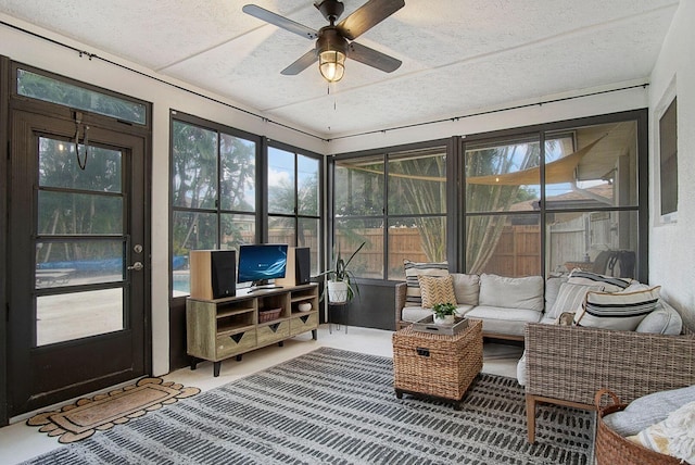 sunroom / solarium featuring ceiling fan and a healthy amount of sunlight