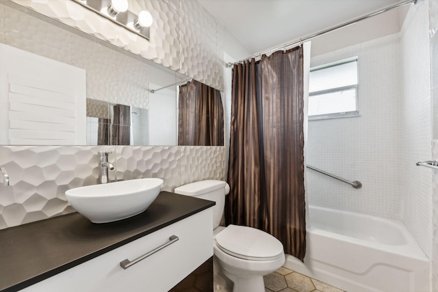 full bathroom with toilet, shower / tub combo, tile walls, vanity, and tasteful backsplash